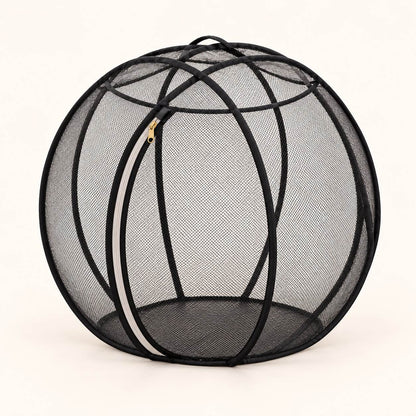 Black mesh pop-up bubble playpen with fabric-covered hoops and a zippered door on a light studio background.
